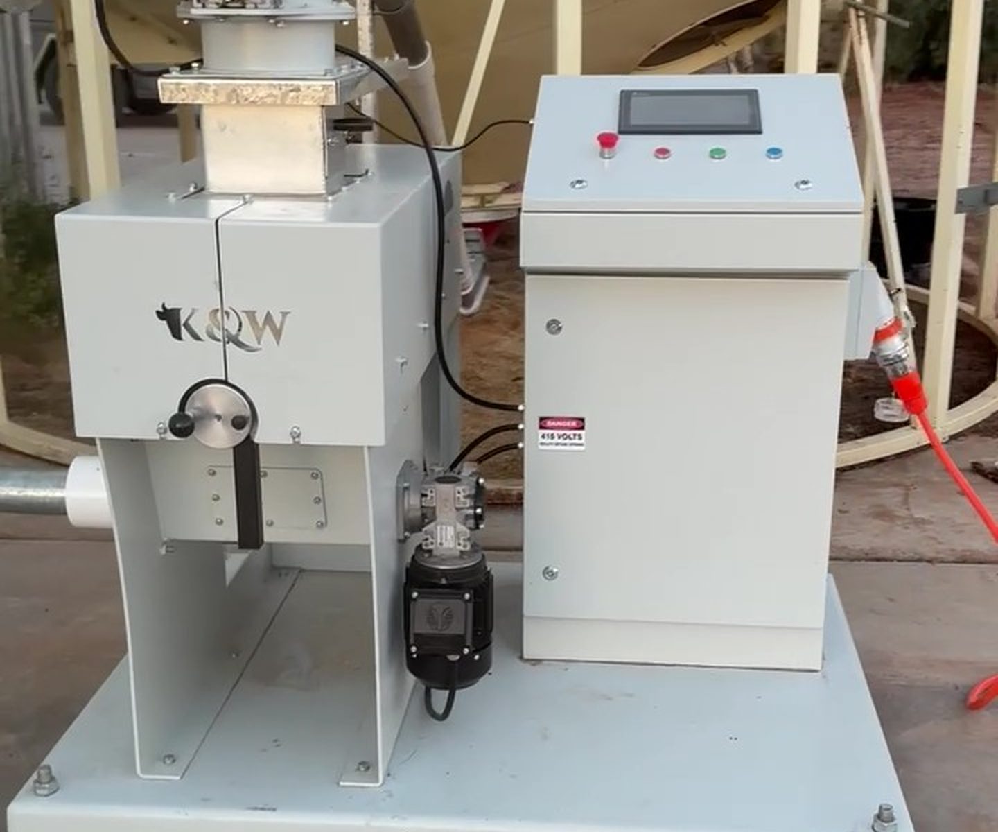K&W M1 Basic mill on its skid in front of a silo